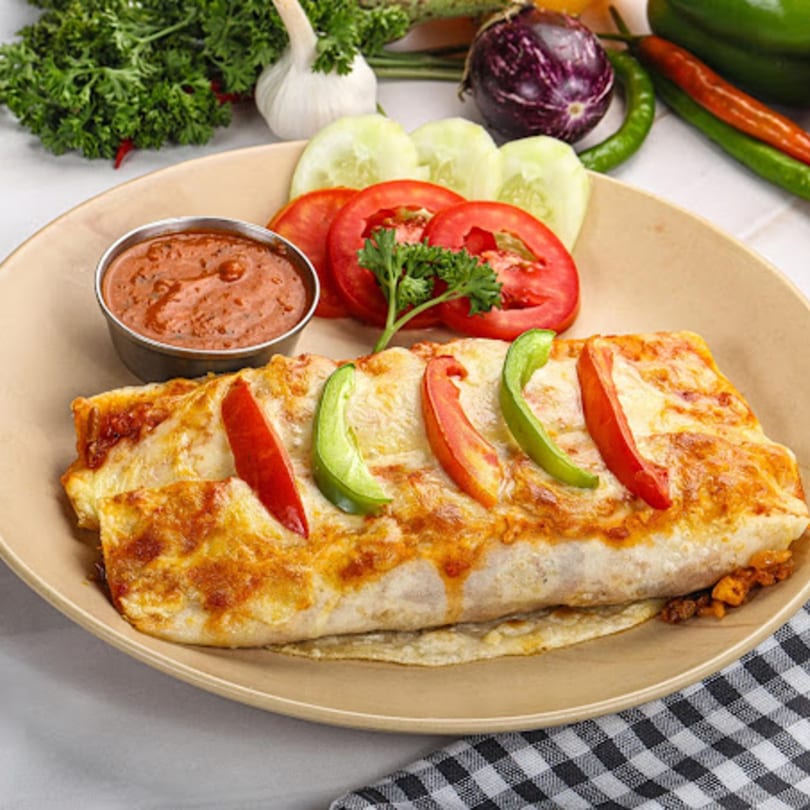 A John's Famous Bagels & Deli burrito with melted cheese, bell peppers, and a side of sauce.